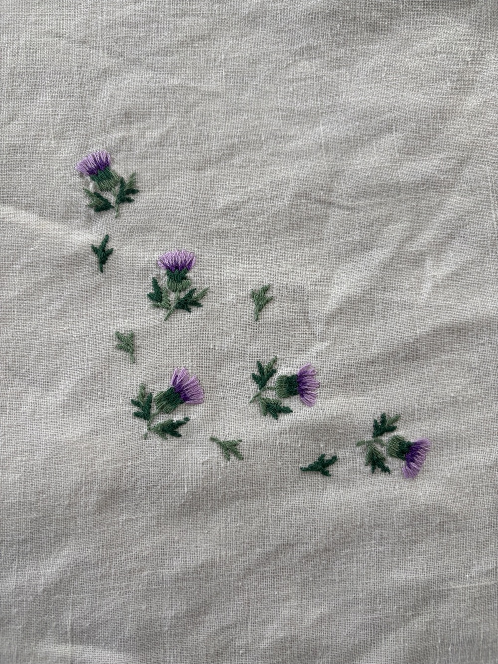 Vintage table topper w/ embroidered thistles, purple trim, linen, 35.5x37.5”